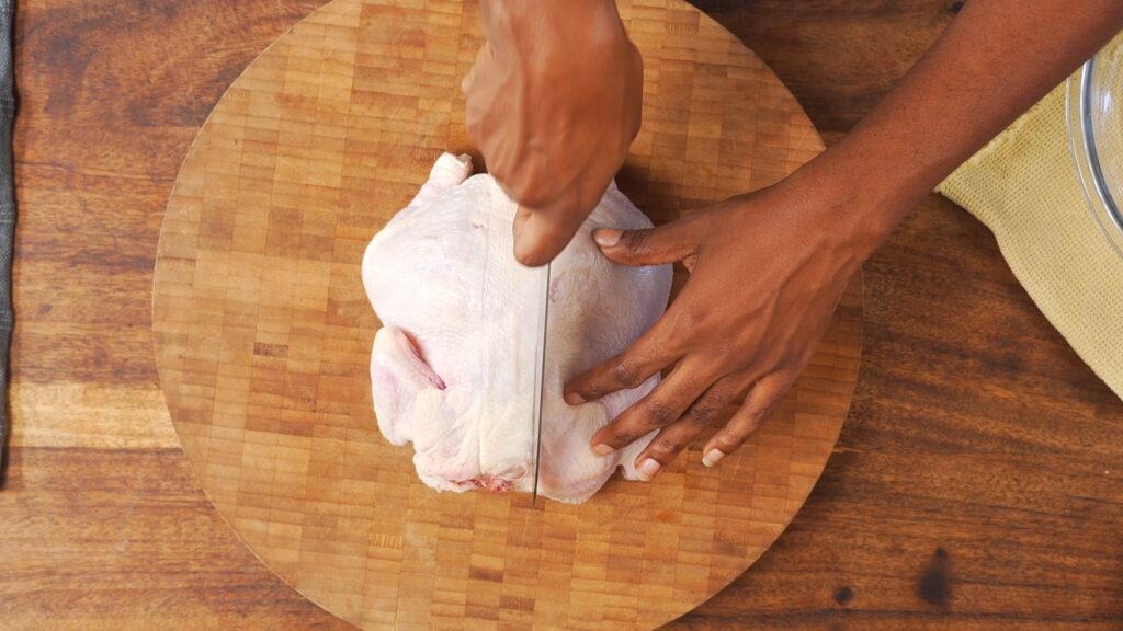 Chef Samantha demonstrating how to cut whole chicken in half